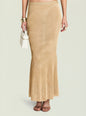 Harmony Metallic Knit Skirt worn by a model paired with a white mini bag and chunky gold bracelets. thumbnail image 1 of 5