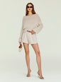 Model wearing a beige oversized knit sweater with an off-shoulder neckline and gold accessories thumbnail image 5 of 5