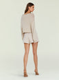 Back view of a beige cropped knit sweater on a model against a pale background thumbnail image 4 of 5