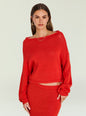 Model wearing bright red Serafina Sweater with a wide boat neckline and relaxed fit, gold earrings visible. thumbnail image 6 of 6