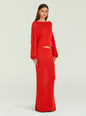 Full-length shot of a model wearing red Serafina Sweater with matching floor-length knit skirt against a pale backdrop. thumbnail image 4 of 6