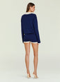 Back view of a model wearing a navy knit romper with white collar and cuffs thumbnail image 5 of 6