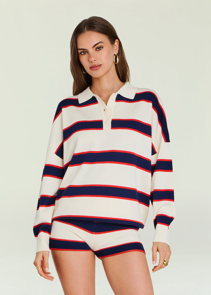 Close up of model wearing Taby Sweater with white base navy and red stripes and polo collar.