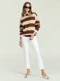 Model in Bryn Knit Sweater with bold beige and brown stripes over a white shirt, wearing sunglasses. thumbnail image 6 of 6