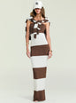 Model facing forward in a brown and cream striped knit maxi dress with a white collar shirt and white baseball cap thumbnail image 5 of 5