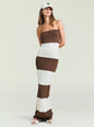Model in a brown and white striped knit maxi dress with a draped scarf over shoulders and a white cap. thumbnail image 1 of 5