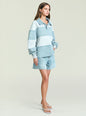 Three tone blue denim top with a collar worn by a model in a side profile. thumbnail image 5 of 6