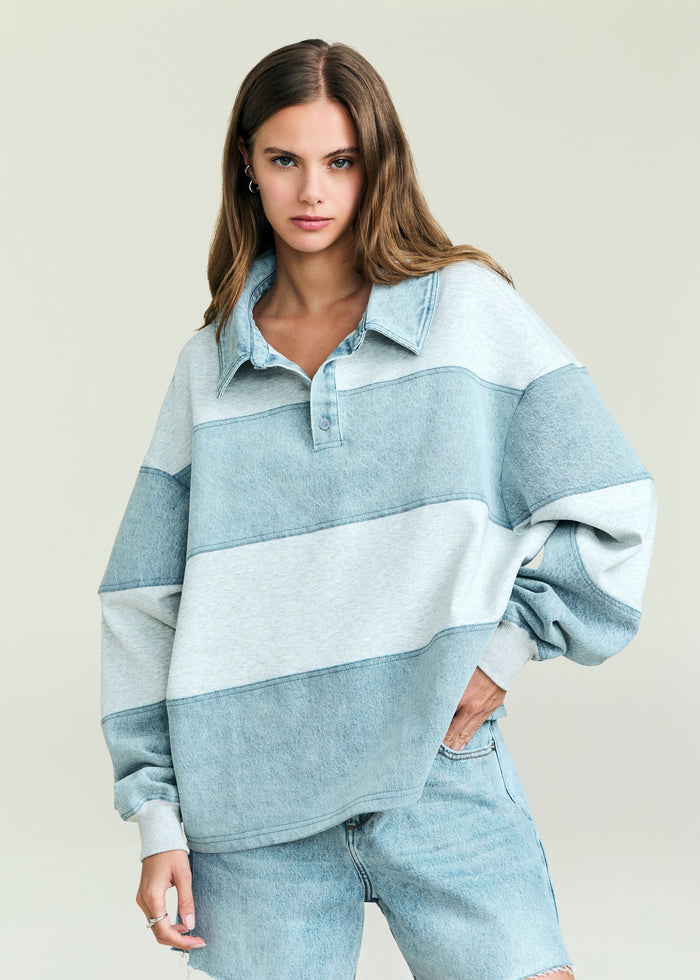 Model wearing a light blue Cher Denim Top with a collar and relaxed two tone denim design