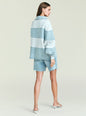 Back view of model wearing Cher Denim Top with horizontal light blue stripes and an oversized fit thumbnail image 4 of 6