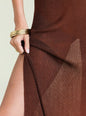 Brown metallic knit dress with a hand adjusting the fabric on a light background thumbnail image 2 of 5