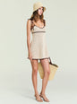 Cream crochet mini dress with brown trim and tie straps worn by a model with a straw hat and tote thumbnail image 5 of 5