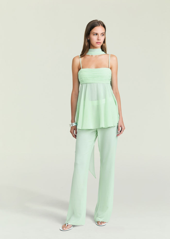 Front view of a model in mint green Tamara Top with halter neckline and twisted front detail