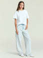 Front view of a model wearing Travis Denim Pant in light gray with a denim waist belt and a white oversized T shirt. thumbnail image 2 of 5