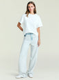 Travis Denim Pant in light wash with a relaxed wide leg and belt worn by a model thumbnail image 5 of 5