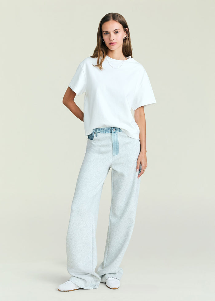 Travis Denim Pant in light wash with a relaxed wide leg and belt worn by a model