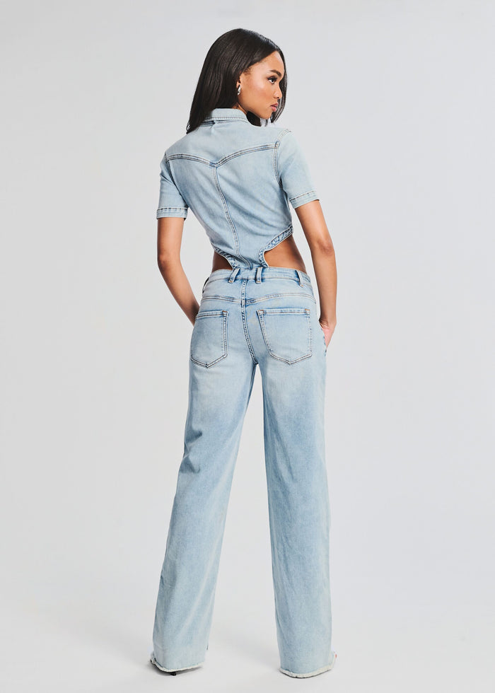 Back view of Karen Jumpsuit in light denim with waist cutouts
