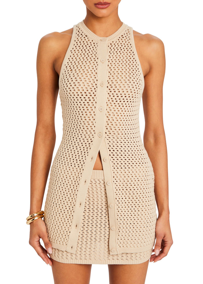 Beige knit crochet mini skirt with an open stitch pattern and front button detailing.