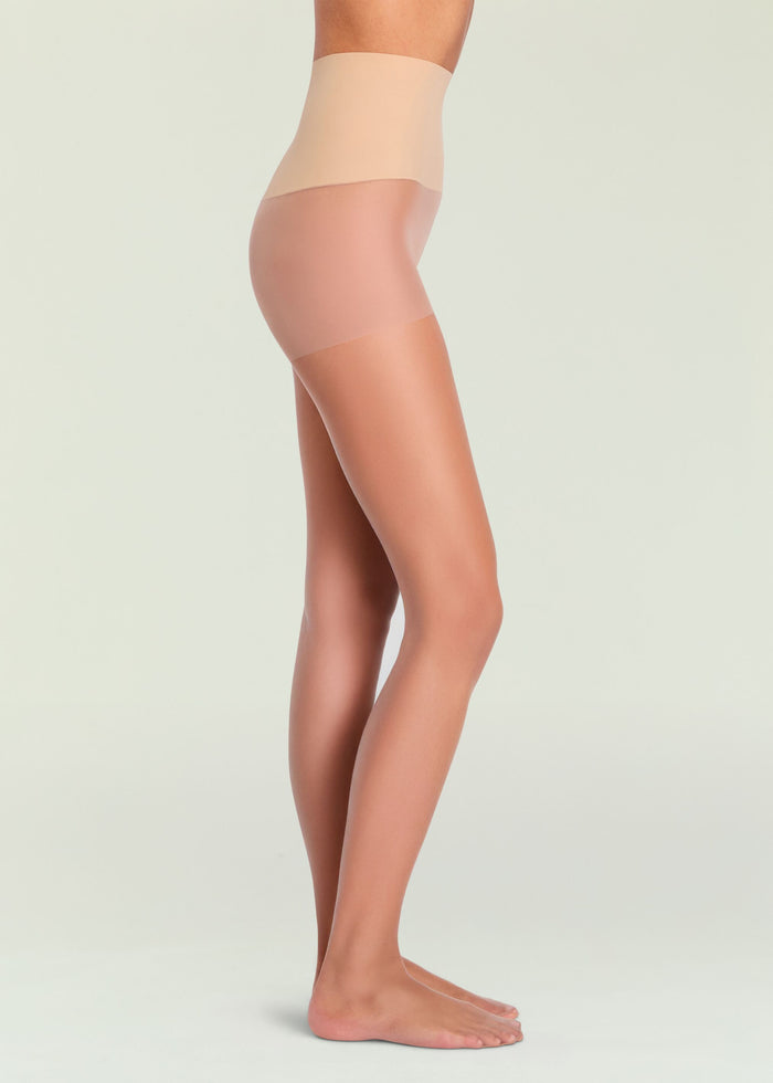Side view of a leg wearing nude Highlighter Sheer Tights with a pale waistband and sheer leg