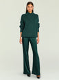 Front view of model wearing emerald green knit sweater and satin pants with gold earrings and black heels thumbnail image 2 of 5