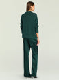 Back view of model in emerald green knit sweater and matching satin pants with gold earrings thumbnail image 5 of 5