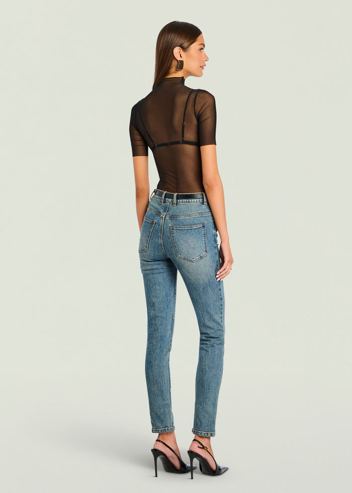 Back view of Gail Bodysuit worn with jeans, sheer black short sleeves and back strap hardware.