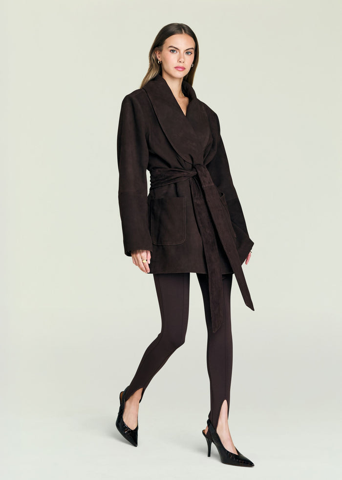 Model wearing a dark brown suede belted coat with a large collar and patch pockets.