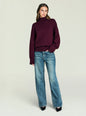Model wearing a burgundy Elsa Turtleneck Sweater with a relaxed fit and ribbed cuffs and hem, paired with jeans. thumbnail image 5 of 5