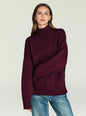 Model wearing a burgundy Elsa Turtleneck Sweater in a relaxed fit with ribbed cuffs and hem thumbnail image 1 of 5