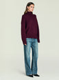 Elsa Turtleneck Sweater in deep burgundy on a model; oversized knit with ribbed cuffs and hem. thumbnail image 2 of 5