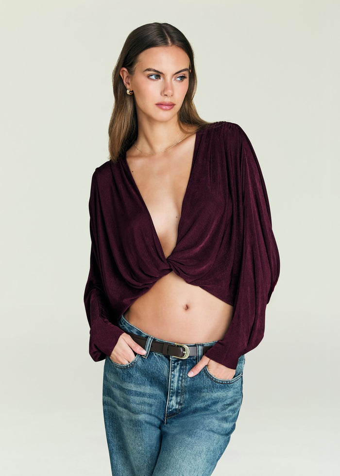 Jerome Top burgundy wrap top with a deep V neckline tied at the front worn with jeans