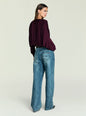 Back view of model wearing burgundy Jerome Top with draped sleeves and jeans. thumbnail image 4 of 5