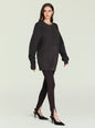 Model wearing a dark oversized knit sweater with a crew neck against a pale backdrop. thumbnail image 3 of 5