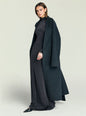 Model wearing a dark charcoal maxi dress with a long overcoat draped over her shoulders. thumbnail image 5 of 5