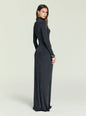 Side view of a model in a dark Kim Maxi Dress with a coat draped over her shoulders thumbnail image 4 of 5
