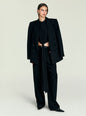 Model wearing a black Laura Top tied at the waist under an oversized black blazer with matching trousers thumbnail image 5 of 5