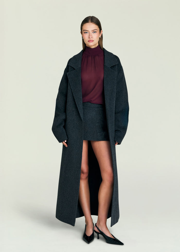 Model wearing a charcoal Lyli Wool Coat over a burgundy turtleneck and matching skirt