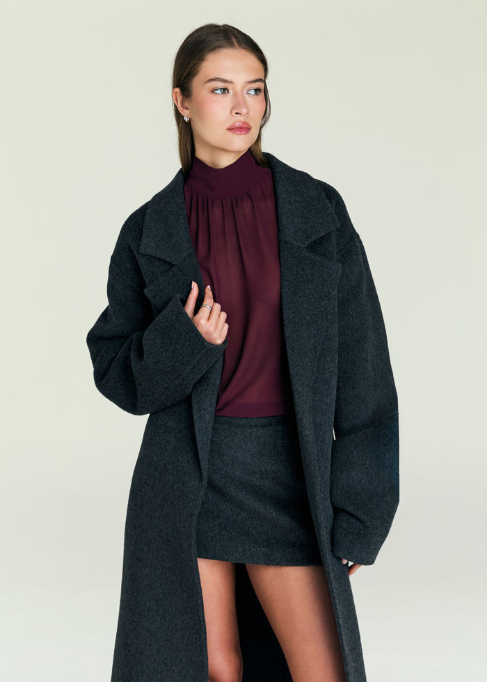 Lyli Wool Coat worn open over a burgundy high neck top with oversized lapels