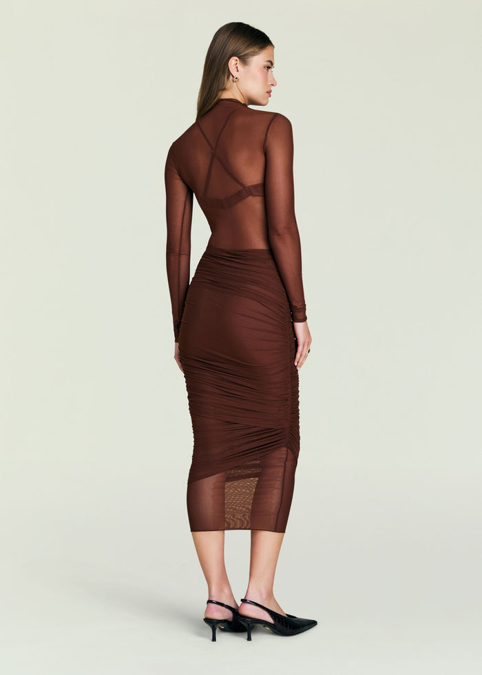 Back view of Thessa Ruched Skirt outfit featuring a sheer brown top and a ruched brown skirt.