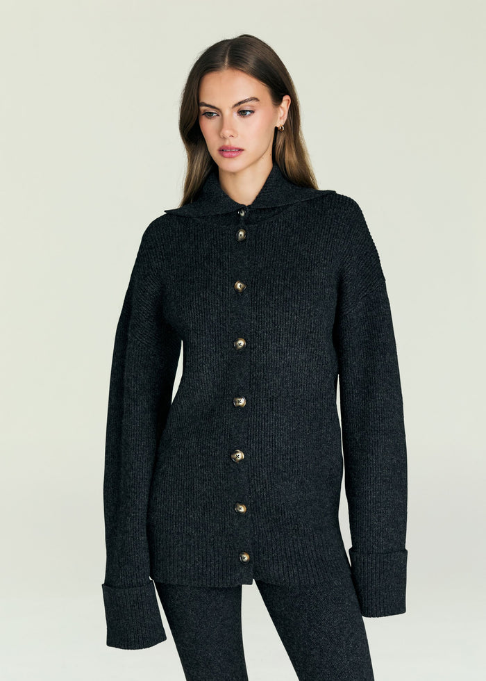 Model wearing Sal Sweater dark knit cardigan with large front buttons and a wide collar