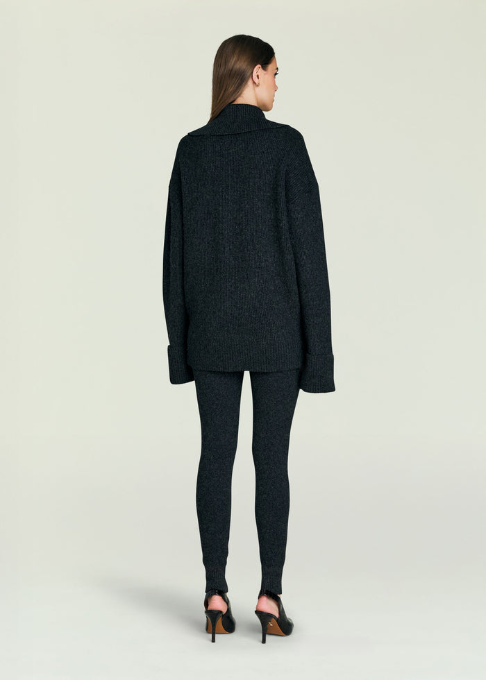 Back view of a model in a dark grey knit sweater with matching pants.