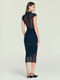 Back view of a model wearing a navy Tabitha Mesh Ruched Midi Dress with sheer mesh upper back. thumbnail image 4 of 5