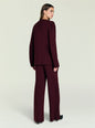 Back view of a model in a burgundy knit set featuring a loose sweater and wide-leg pants. thumbnail image 4 of 5