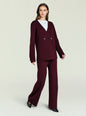 Model in burgundy Tundra Sweater wrap cardigan with double buttons over white top and matching pants. thumbnail image 2 of 5