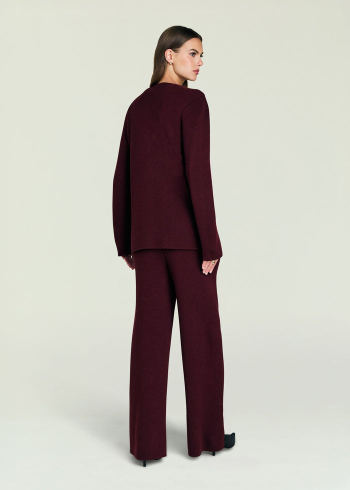 Back view of a model in burgundy Tundra Sweater wrap cardigan with matching pants.