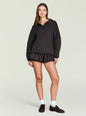 Front view of a model in a dark Vespen Sweater featuring a polo collar and button placket. thumbnail image 5 of 5