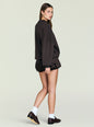 Side profile of a model wearing a dark Vespen Sweater with dropped shoulders and ribbed cuffs. thumbnail image 4 of 5
