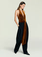 Side view of model wearing burnt orange Vika Velvet Bodysuit with halter neck and waist knot thumbnail image 2 of 5