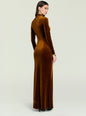Back view of a woman wearing a caramel brown velvet maxi dress with a halter neck and open back. thumbnail image 4 of 5