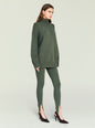 Model wearing olive green Kelsey Stirrup Leggings paired with an oversized knit sweater thumbnail image 3 of 5