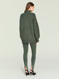 Back view of model wearing olive green Kelsey Stirrup Leggings and an oversized sweater thumbnail image 4 of 5